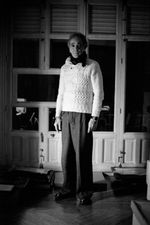 Brown painted wall with two benches and dim light above