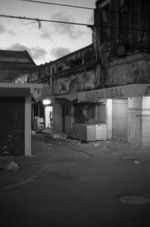 Buildings during nighttime with orange lighting and water below