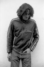 Gota de agua generando salpicaduras hacia arriba en fondo oscuro